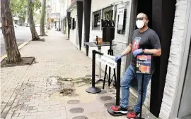  ?? JIM WYSS jwyss@miamiheral­d.com ?? Jose Matos stands outside his pizzeria, Rizzeria, in San Juan, Puerto Rico, on March 24, 2020. The government has shut down all non-essential businesses for two weeks to confront the coronaviru­s, and shops like Matos’ are suffering.