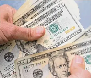  ?? Elise Amendola / Associated Press ?? Rising prices can feel impossible to manage if money is already tight. To stay afloat, prioritize essential expenses that enable you to live and work.