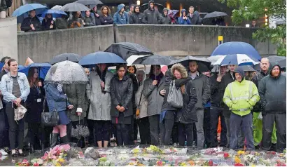  ?? AFP ?? A woman reacts as people observe a minute’s silence in London on Tuesday in memory of the victims of the June 3 terror attacks. —