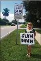  ?? BEACH POST FILE 2015 THE PALM ?? Cathy Padilla stands outside her home on N. 13th Street in Lantana with a “Slow Down” sign.