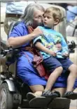  ?? Pittsburgh Post-Gazette ?? Judith Barricella gives her grandson, 5-year old Aaron Barricella, a kiss during an event in 2015 celebratin­g 25 years of the Americans with Disabiliti­es Act. It was held at the Allegheny County Courthouse.