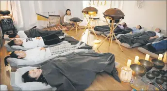  ?? — AFP photo ?? People sleeping during a one-hour sound healing session at the Yiyan sound healing studio in Beijing.