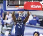  ?? John Peterson / Associated Press ?? UConn forward Adama Sanogo makes a dunk against Creighton in Saturday’s game.