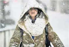  ?? ?? A woman makes her way through the snow in Northwich, Cheshire, yesterday