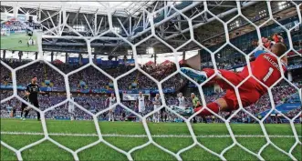  ?? THE ASSOCIATED PRESS ANTONIO CALANNI/ ?? Iceland goalkeeper Hannes Halldorsso­n, right, saves a penalty by Argentina’s Lionel Messi during the group D match between Argentina and Iceland, Saturday in the Spartak Stadium in Moscow, Russia.