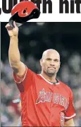  ??  ?? Tips his cap to the fans after collecting his 3,000th hit. ALBERT PUJOLS