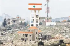  ??  ?? A general view shows a tower and buildings on the Lebanese side of the border between Israel and Lebanon, as it is seen from the Israeli side of the border. — Reuters photo