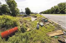  ?? VASHA HUNT AP ?? Debris from a tropical depression is strewn along a road in Northport, Ala., Sunday. The storm has spurred tornadoes and flash flooding across the region.