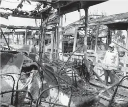  ?? SUNDAY ALAMBA/AP PHOTOS ?? The charred remains of buses Saturday in Lagos, Nigeria, after days of peaceful protests over police abuses turned deadly. A 24-hour curfew was loosened Saturday in the city.