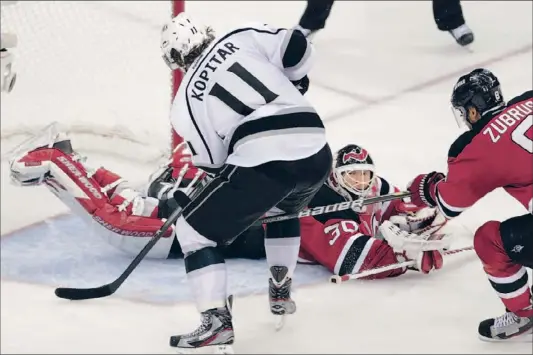  ?? Robert Gauthier Los Angeles Times ?? ANZE KOPITAR BEATS MARTIN BRODEUR for the winning goal in overtime, giving the Kings their ninth consecutiv­e road win in the playoffs this year and their 11th on the road over two seasons. “You know, it happened pretty quick. I was able to finish it...