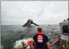  ?? (U.S. COAST GUARD VIA AP ?? In this photo provided by the U.S. Coast Guard, A Coast Guard Station Grand Isle 45-foot Response Boatmedium boat crew member searches for survivors near the capsized SeaCor Power.