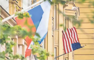  ??  ?? A Russian flag flies next to the US embassy building in Moscow. — AFP photo