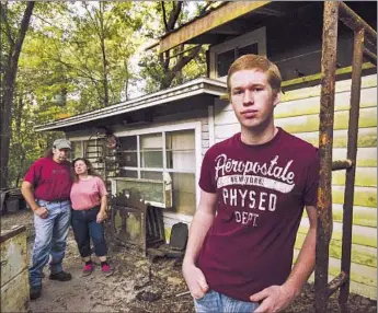  ?? William Colgin
For The Times ?? TEN YEARS AFTER clinging to one another in swirling water, Dillion Chancey, 17, and his parents, Bobby Danny Chancey and Sarah Fairchild, live on their land in D’Iberville, Miss., farther from the coast.