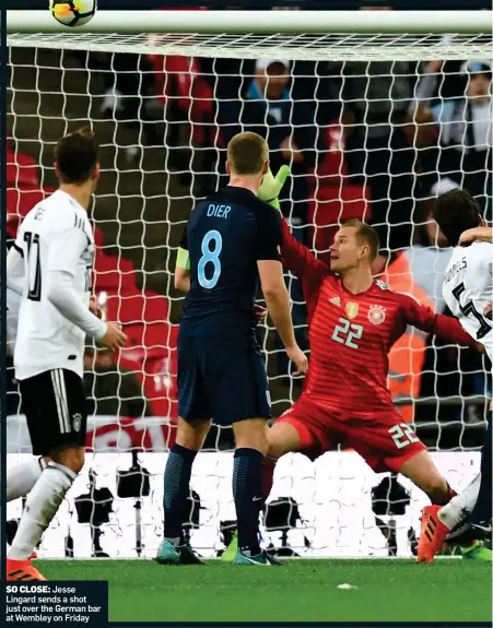  ??  ?? SO CLOSE: Jesse Lingard sends a shot just over the German bar at Wembley on Friday