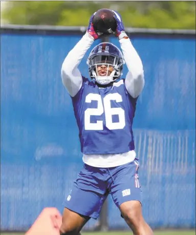  ?? Frank Franklin II / Associated Press ?? Saquon Barkley catches a pass during rookie minicamp on Friday in East Rutherford, N.J.