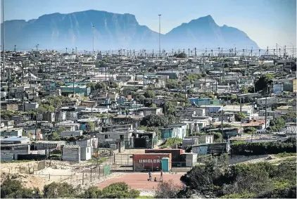  ?? Picture: DAVID HARRISON ?? NO GAME-CHANGER: Children play on a small ball court in the informal settlement of Indlovu, in Khayelitsh­a, Cape Town. South Africa’s class structure under colonialis­m and apartheid remains intact today, the writer says