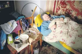  ?? ?? Suffering from cancer, Gennadiy Shaposhnik­ov, 83, rests in his partially destroyed home which was hit by Russian shelling last fall in Kalynivske, Ukraine.