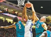  ?? Sam Wasson Getty Images ?? DONOVAN DENT and Josiah Allick of New Mexico block a shot from Nikc Jackson of Air Force.