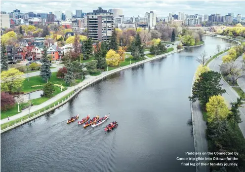  ??  ?? Paddlers on the Connected by Canoe trip glide into Ottawa for the final leg of their ten- day journey.