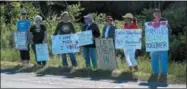  ?? CHARLES PRITCHARD — ONEIDA DAILY DISPATCH ?? A group of protesters stand outside the Suit-Kote headquarte­rs on Monday, July 9, 2018.