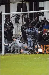  ??  ?? Fred Chapman is sent the wrong way from the penalty spot.