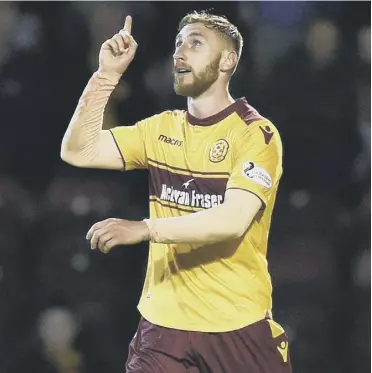  ??  ?? Louis Moult celebrates scoring his second goal in Motherwell’s defeat of Aberdeen on Thursday.