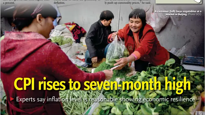  ?? Photo: VCG ?? A customer (left) buys vegetables at a market in Beijing.