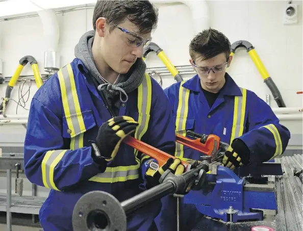  ?? LARRY WONG ?? Phillip Salisbury, left, and Dylan Johanson, both 16, are enrolled in the plumbing program at Archbishop O’Leary High School.