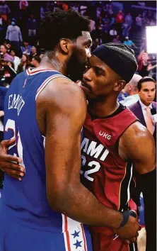  ?? Matt Slocum / Associated Press ?? The Heat’s Jimmy Butler (right) consoles his former 76ers teammate, Joel Embiid, after Miami eliminated Philadelph­ia.