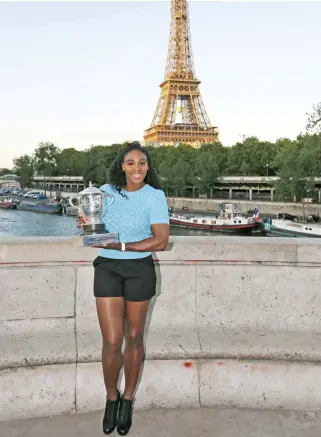  ??  ?? PERFECT POSE: Serena Williams of the U.S. poses with her trophy near the Eiffel Tower in Paris, after winning the French Open women’s singles final at the Roland Garros.