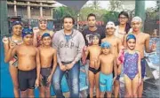  ??  ?? Swimmers from Fr Agnels’ Sports Centre with their coach Gokul Kamath (centre) after winning the YMCA meet.