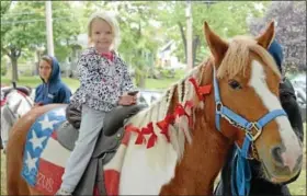  ?? News-herald photos — DEBBY HIGH ?? Tessa Farrell, 4, take a ride on a horse named Beezuz.