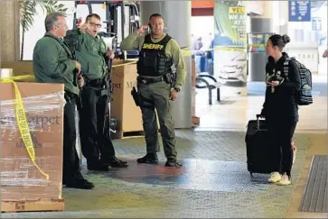  ?? Taimy Alvarez South Florida Sun Sentinel ?? SHERIFF’S DEPUTIES at the airport in Fort Lauderdale, Fla. Authoritie­s say Esteban Santiago shot and killed five people at the airport on Friday. Just two months earlier, he had told the FBI he was delusional.