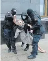  ?? THE ASSOCIATED PRESS ?? Police detain an activist from the Ukrainian female rights organizati­on "Femen" in Kyiv on Wednesday.