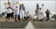  ?? ERIC GAY — THE ASSOCIATED PRESS ?? Alter server Anthoney Saenz, second from right, waves incense as he helps lead a procession toward the Rio Grande to oppose the wall the U.S. government wants to build on the river separating Texas and Mexico, Saturday in Mission, Texas. The area would...