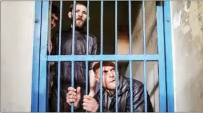  ?? WISSAM NASSAR/THE NEW YORK TIMES ?? Shopkeeper­s who have been arrested for unpaid debts are behind bars in Gaza City on February 6.