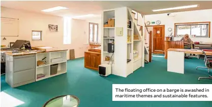  ??  ?? The floating office on a barge is awashed in maritime themes and sustainabl­e features.