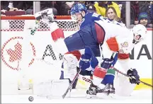  ??  ?? Vancouver Canucks’ Bo Horvat (back), tries to get his stick on the puck as Florida Panthers’ Keith Yandle (front), defends after goalie James Reimer made a save during the first period of an NHL hockey game on Feb 14, in
Vancouver, British Columbia....