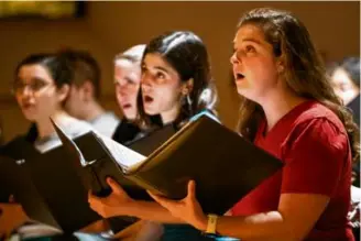  ?? TANNER PEARSON FOR THE BOSTON GLOBE ?? Mikaela Bartels, board president of Longwood Chorus and a certified child life specialist at Boston Children’s Hospital, sings at choir practice last month at St. Paul’s Episcopal Church in Brookline.