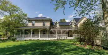  ??  ?? This two-storey board-and-batten features a huge landscaped front yard with many mature trees and gardens.