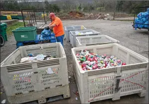  ?? (NWA Democrat Gazette/Caleb Grieger) ?? Matt Partain sorts through bags of recycling at Boston Mountain Solid Waste District in Prairie Grove on Friday. Boston Mountain Solid Waste District is running a trial program with rural workers in an effort to increase the amount of recycling in the community.