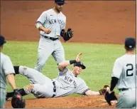  ?? Chris O’Meara / Associated Press ?? New York Yankees third baseman DJ LeMahieu makes a diving catch on an infield popout by the Tampa Bay Rays’Mike Zunino during the second inning on Friday.