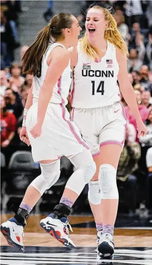  ?? Jessica Hill / Associated Press ?? UConn’s Dorka Juhasz (14) celebrates after her 3-point basket with teammate Nika Muhl in the second half against Villanova on Sunday.