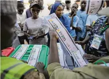  ?? Sunday Alamba/Associated Press ?? Election officials count ballots in front of observers in Yola, Nigeria. Some were casting votes well into the night.