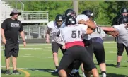  ?? Scott Herpst ?? New Ridgeland head coach Craig Pritchett works with the offensive and defensive linemen during a spring practice session at Bowers and Painter Field last Monday afternoon. The Panthers will scrimmage at Gordon Central this Friday night.