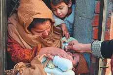  ?? AFP ?? ■ A health worker administer­s polio vaccine drops to a child during a vaccinatio­n campaign in Lahore.