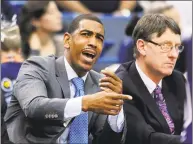  ?? Fred Beckham / Associated Press ?? Former UConn coach Kevin Ollie and associate head coach Glenn Miller watch a 2013 game in Hartford. Ollie has filed a lawsuit against, contending Miller slandered him in comments to the NCAA.