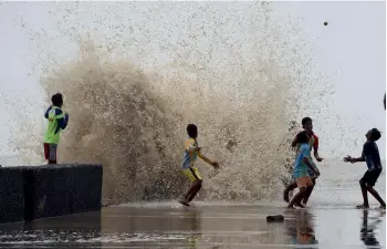  ?? — PTI ?? Children enjoy the high tide at the seafront in Mumbai on Monday.