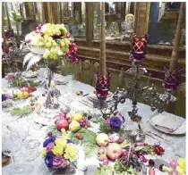 ??  ?? A recreation of a royal dinner with Victorian silver and an abundance of fruits and flowers