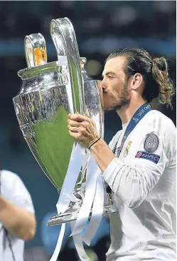  ?? Picture: Getty. ?? Real Madrid’s Gareth Bale with the Champions League Trophy. Short of a financial bubble bursting, the domination of European competitio­ns by ‘uber’ clubs is here to stay, with Scottish sides consigned to also-ran status.